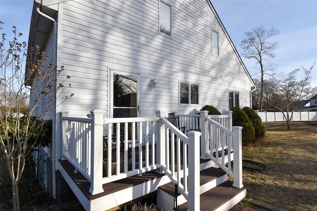 rear view of property featuring a wooden deck