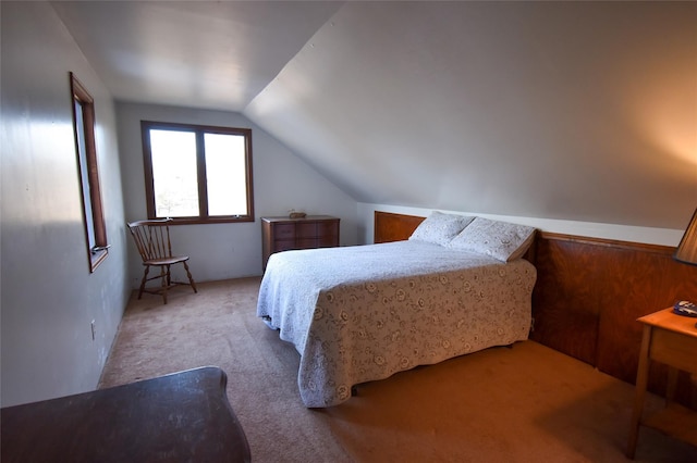 bedroom featuring lofted ceiling and light carpet