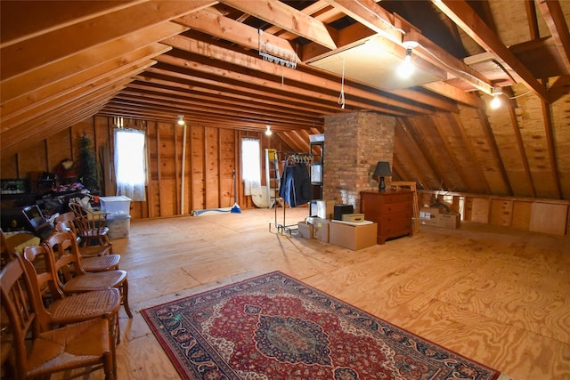 unfinished attic featuring a healthy amount of sunlight