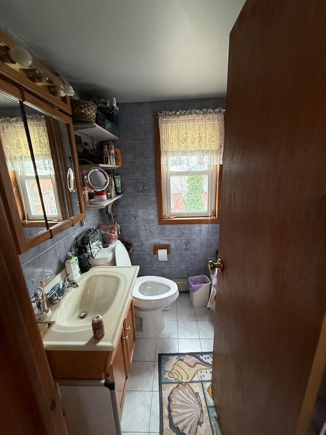 bathroom featuring tasteful backsplash, tile walls, tile patterned flooring, vanity, and toilet