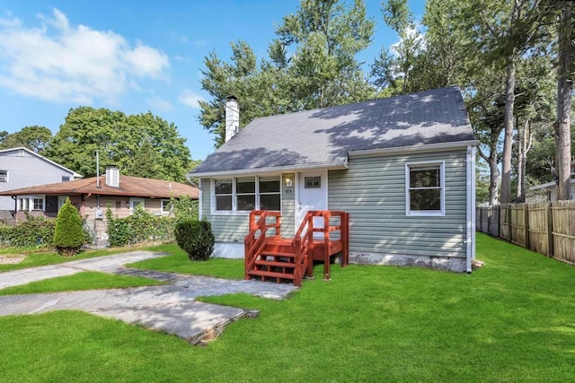 rear view of house with a lawn