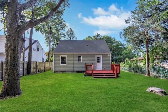 back of house with a yard and a deck