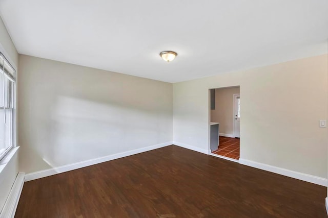 empty room with dark hardwood / wood-style floors