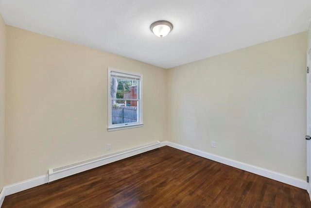 spare room featuring hardwood / wood-style floors and baseboard heating