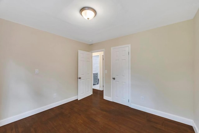 spare room featuring dark hardwood / wood-style flooring