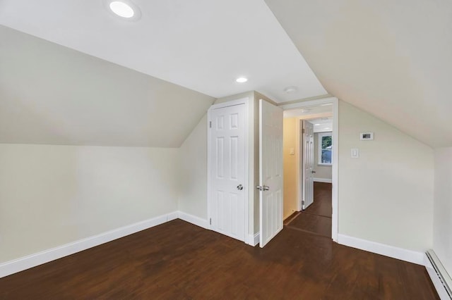 bonus room with lofted ceiling, dark hardwood / wood-style floors, and a baseboard heating unit