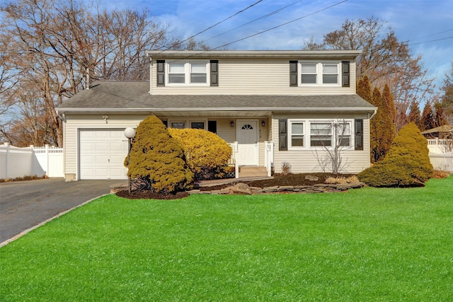 view of front of property with a garage and a front lawn