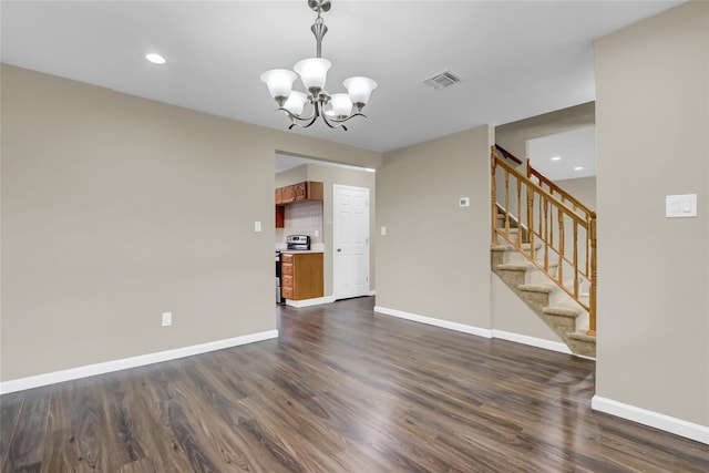 unfurnished living room featuring dark hardwood / wood-style floors and a chandelier