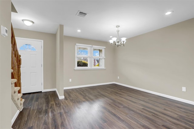 entrance foyer featuring dark wood-type flooring and a chandelier