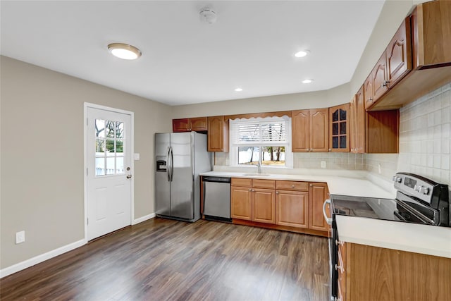 kitchen with tasteful backsplash, sink, stainless steel appliances, and a healthy amount of sunlight