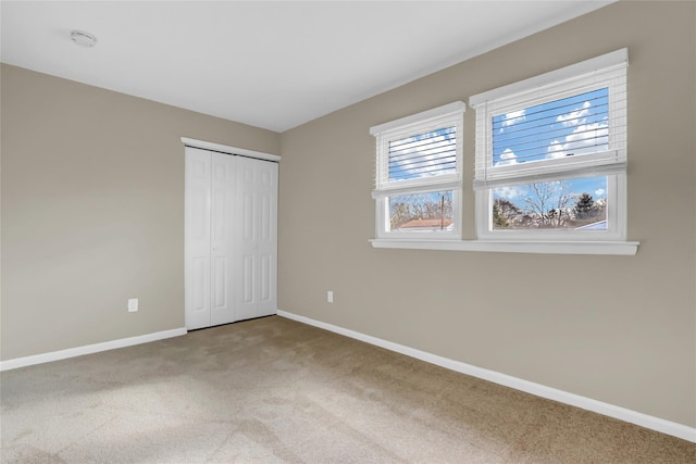 unfurnished bedroom with a closet and carpet