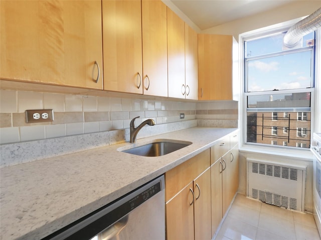 kitchen featuring sink, light stone counters, stainless steel dishwasher, radiator heating unit, and backsplash