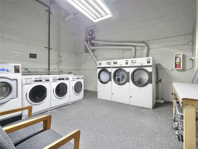 clothes washing area with washing machine and dryer