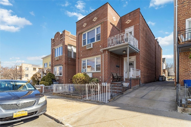 view of front facade featuring a fenced front yard and brick siding