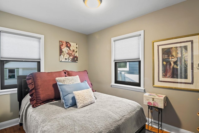 bedroom with dark wood-type flooring