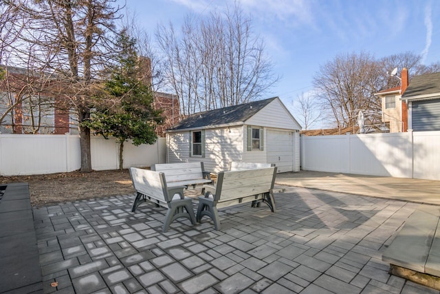 view of patio / terrace featuring an outbuilding and a garage