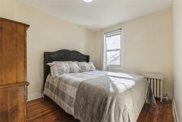 bedroom with dark wood-type flooring