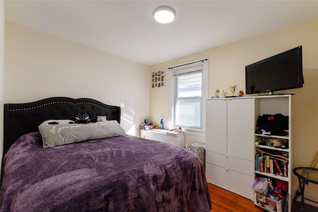 bedroom with hardwood / wood-style floors