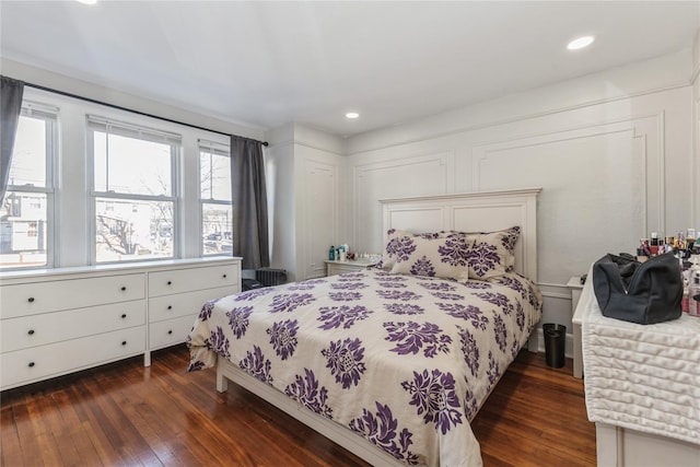 bedroom with dark hardwood / wood-style floors