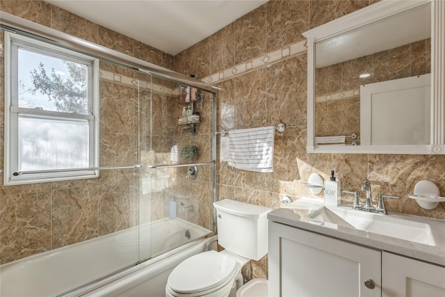 full bathroom with toilet, bath / shower combo with glass door, tile walls, vanity, and backsplash