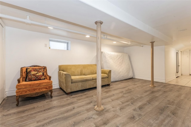 basement with hardwood / wood-style flooring