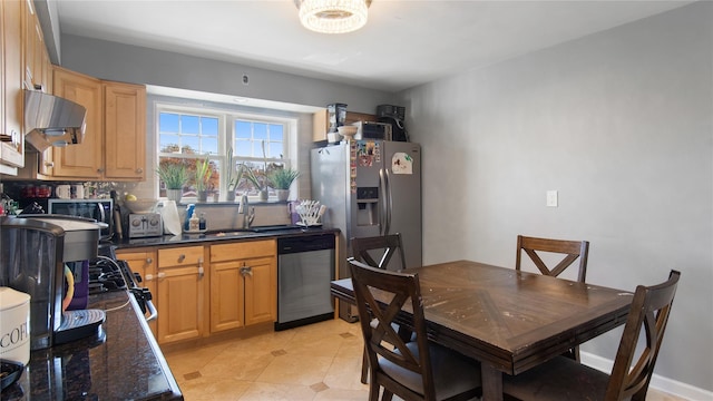 kitchen with appliances with stainless steel finishes, range hood, sink, dark stone countertops, and decorative backsplash