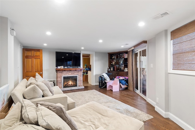 living room featuring a fireplace and dark hardwood / wood-style floors