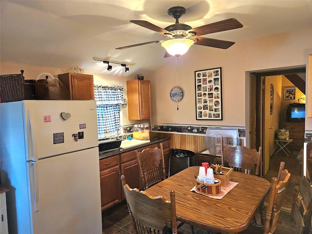 kitchen featuring dark tile patterned flooring, rail lighting, ceiling fan, and white refrigerator