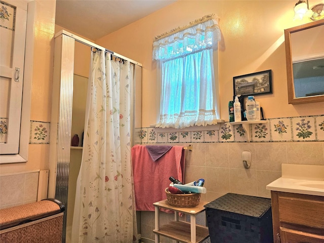 bathroom featuring tile walls, vanity, and walk in shower