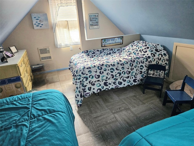 bedroom featuring lofted ceiling and heating unit