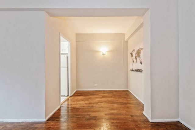 hallway with dark hardwood / wood-style floors