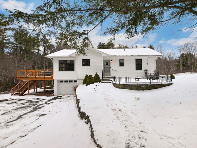 view of front of property featuring a wooden deck and a garage