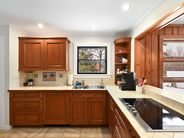 kitchen featuring black electric cooktop, sink, tile counters, and ornamental molding