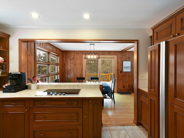 kitchen with a healthy amount of sunlight, tile counters, and black electric cooktop