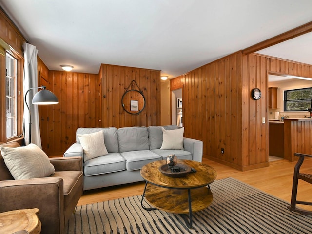 living room featuring light hardwood / wood-style floors and wood walls