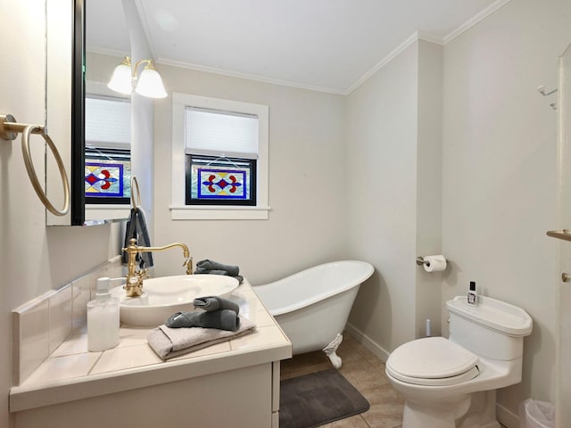 bathroom featuring vanity, ornamental molding, toilet, and a bathing tub