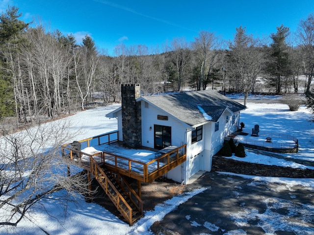 snow covered property featuring a deck