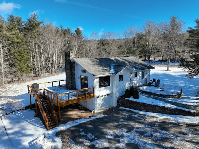 exterior space featuring a garage and a wooden deck