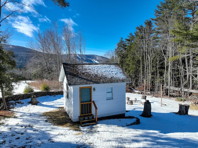 snow covered structure with a mountain view