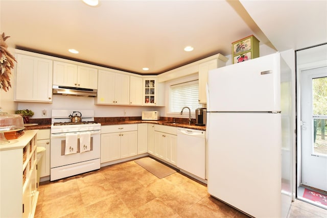 kitchen with white cabinetry, sink, and white appliances