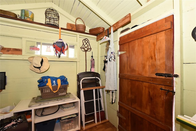 mudroom featuring wooden ceiling, wooden walls, and vaulted ceiling with beams