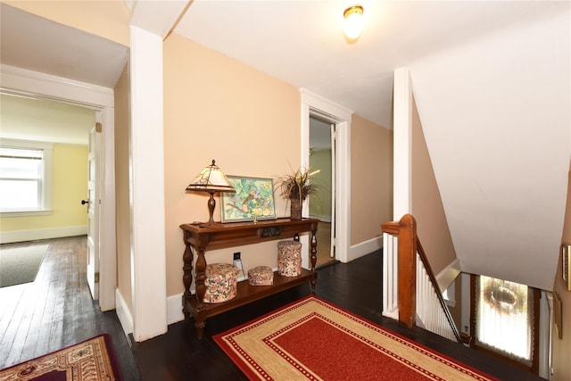 hall with dark wood-type flooring