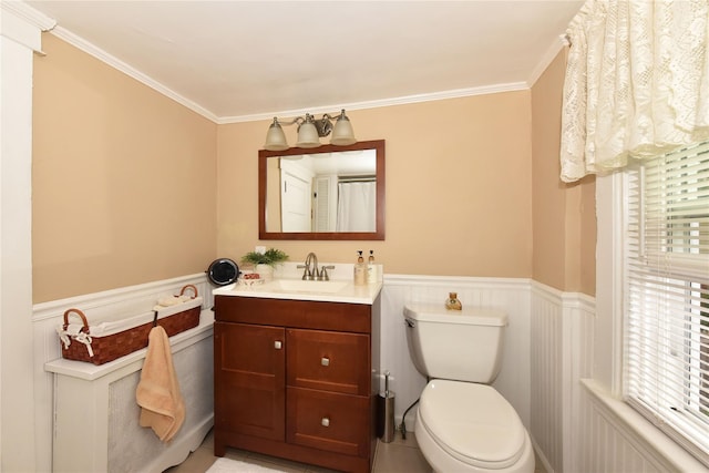 bathroom with crown molding, vanity, and toilet