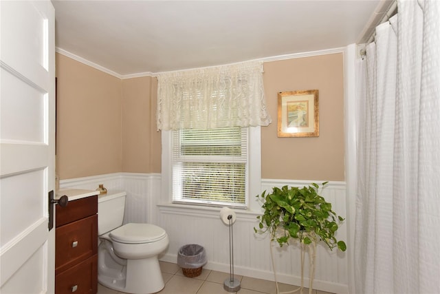 bathroom with tile patterned flooring, vanity, crown molding, and toilet