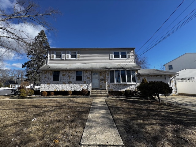 view of front facade with a garage and a front lawn