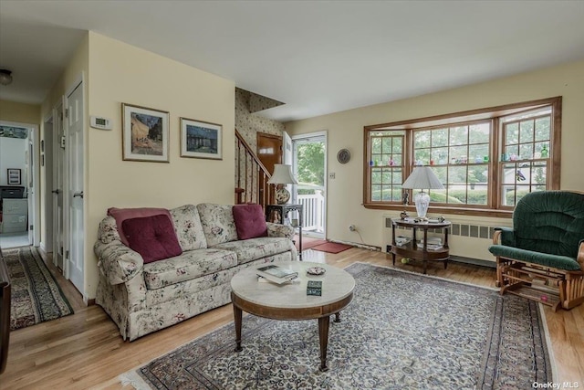 living room featuring radiator heating unit and light hardwood / wood-style flooring