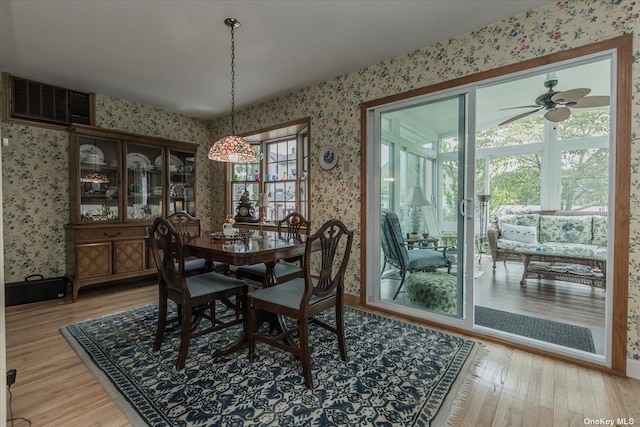 dining room with hardwood / wood-style flooring and ceiling fan