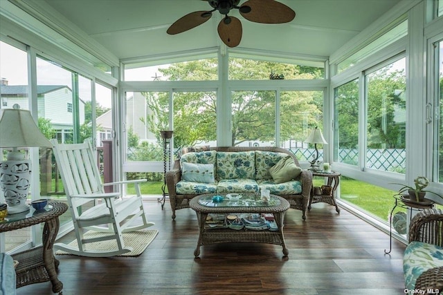 sunroom with lofted ceiling, ceiling fan, and a healthy amount of sunlight