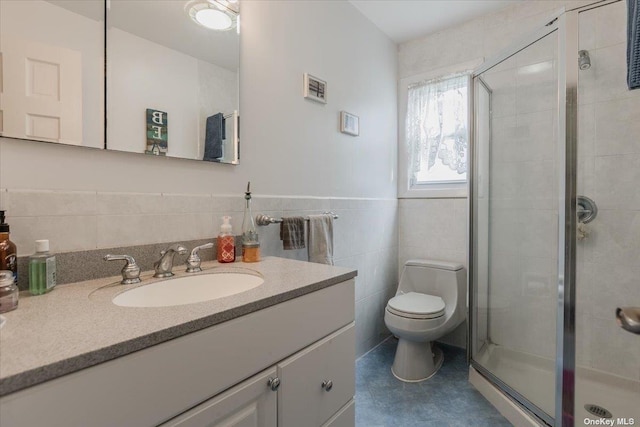 bathroom with tile walls, vanity, toilet, and walk in shower