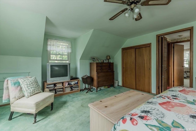 bedroom featuring vaulted ceiling, light colored carpet, and ceiling fan